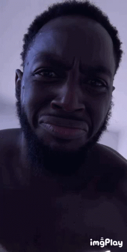 A Man With A Beard Is Making A Funny Face With Imgplay In The Corner GIF