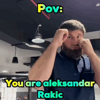 A Man With A Beard Is Making A Funny Face With The Caption " Pov : You Are Aleksandar Rakic " GIF