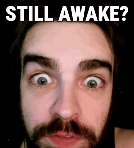 A Man With A Beard Is Making A Funny Face With The Words Still Awake Below Him GIF