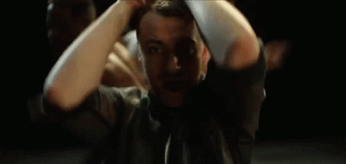 A Man With A Beard Is Making A Hand Gesture With His Hands GIF