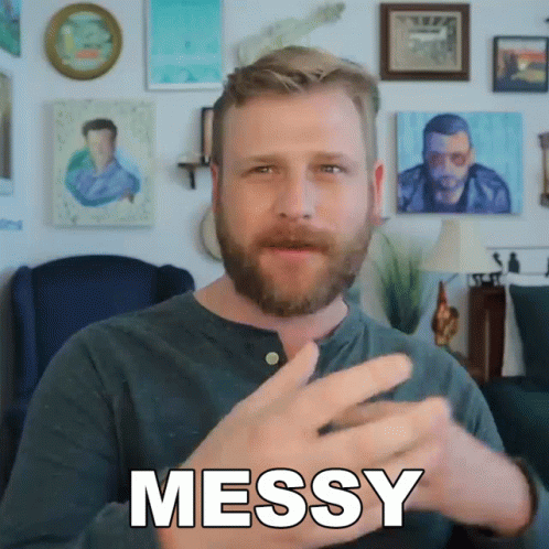 A Man With A Beard Is Making A Messy Gesture With His Hands GIF