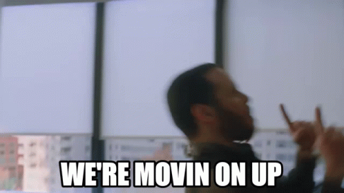 A Man With A Beard Is Making A Peace Sign And Says `` We 'Re Movin On Up '' GIF