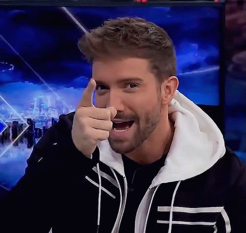 A Man With A Beard Is Pointing At The Camera With His Thumb GIF