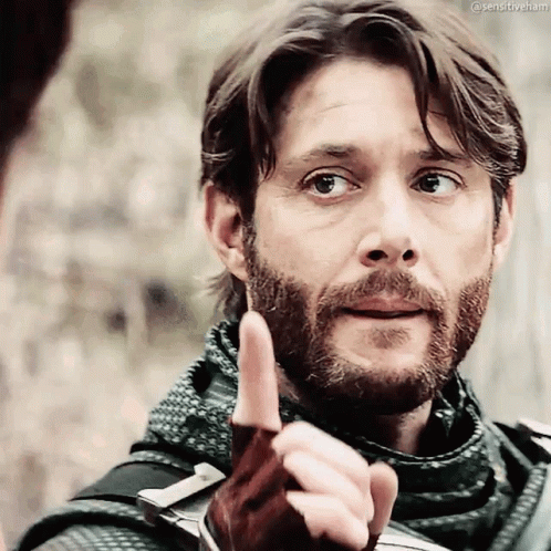 A Man With A Beard Is Pointing His Finger At Something GIF