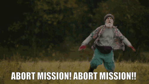 A Man With A Beard Is Running In A Field With The Words Abort Mission Behind Him GIF