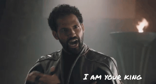 A Man With A Beard Is Saying " I Am Your King " In Front Of A Fire GIF