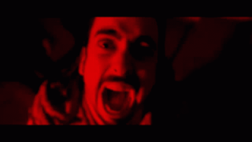 A Man With A Beard Is Screaming In The Dark GIF
