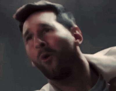 A Man With A Beard Is Screaming With His Mouth Wide Open GIF