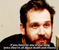 A Man With A Beard Is Singing Into A Microphone With Lyrics About Death GIF