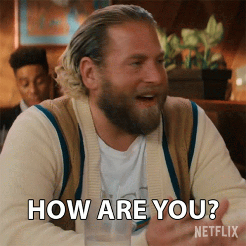 A Man With A Beard Is Sitting At A Table And Says How Are You Netflix GIF