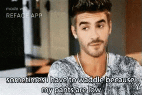 A Man With A Beard Is Sitting At A Table And Says Sometimes I Have To Waddle Because My Pants Are Low GIF