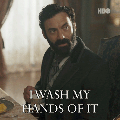 A Man With A Beard Is Sitting At A Table With A Cup Of Coffee And Says I Wash My Hands Of It GIF