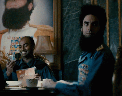 Bearded Man Sitting At Coffee Table GIF