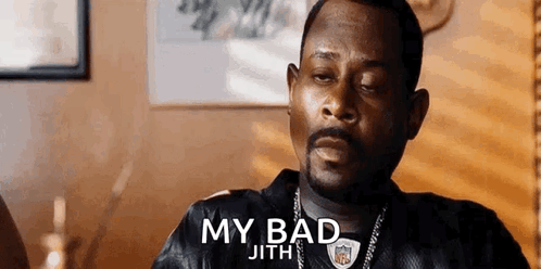 A Man With A Beard Is Sitting At A Table With His Eyes Closed And A Nfl Jersey On . GIF