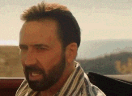 A Man With A Beard Is Sitting In A Car And Making A Face . GIF