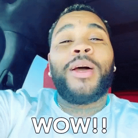 A Man With A Beard Is Sitting In A Car And Making A Funny Face . GIF