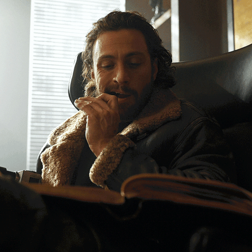 Bearded Man Sitting And Smoking Cigarette GIF
