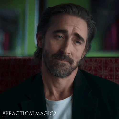 a man with a beard is sitting in a chair with the hashtag #practicalmagic2