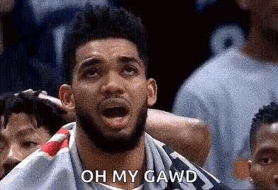 A Man With A Beard Is Sitting In A Crowd Watching A Basketball Game And Saying `` Oh My Gawd '' . GIF