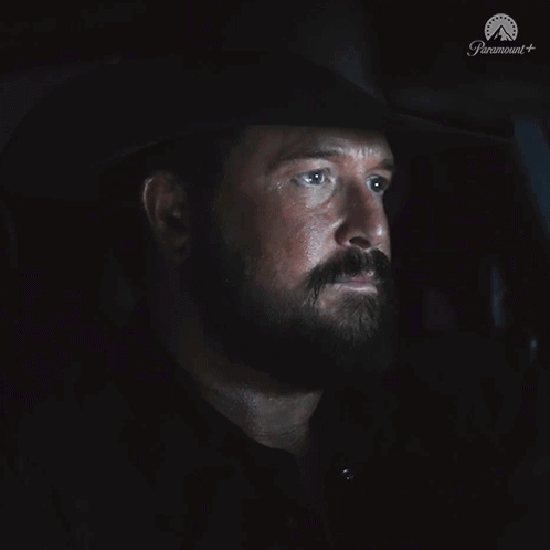 A Man With A Beard Is Sitting In A Dark Room With The Word Nope On The Bottom GIF
