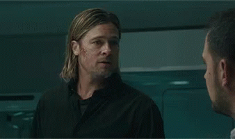 A Man With A Beard Is Sitting In A Laboratory Looking At Something . GIF