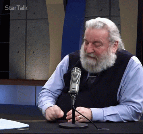 A Man With A Beard Is Sitting In Front Of A Microphone With Startalk Written On The Bottom Right GIF