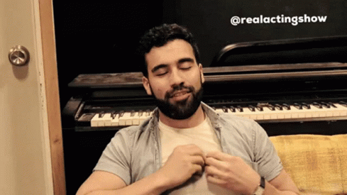 A Man With A Beard Is Sitting In Front Of A Piano With The Hashtag @Realactingshow GIF