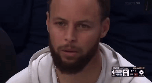 A Man With A Beard Is Sitting In Front Of A Screen That Says Tnt On It GIF