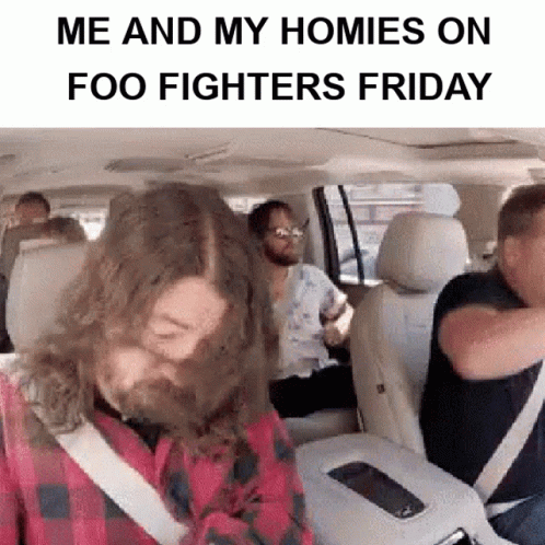 A Man With A Beard Is Sitting In The Back Seat Of A Car With Other People .. GIF