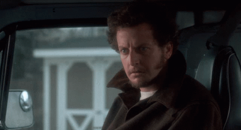 A Man With A Beard Is Sitting In The Back Seat Of A Vehicle GIF