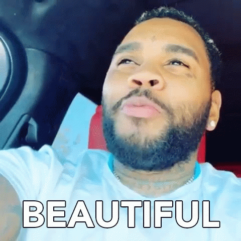 A Man With A Beard Is Sitting In The Driver 'S Seat Of A Car And The Word Beautiful Is On The Screen . GIF