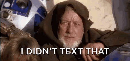 A Man With A Beard Is Sitting Next To A R2d2 Robot . GIF