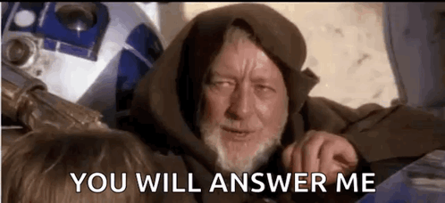 A Man With A Beard Is Sitting Next To A Robot And Says `` You Will Answer Me '' . GIF