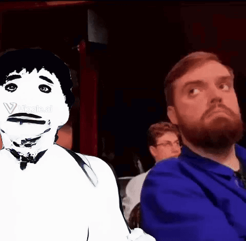 A Man With A Beard Is Sitting Next To Another Man With A White Face GIF