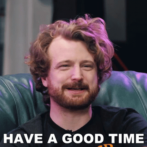 A Man With A Beard Is Sitting On A Couch With The Words Have A Good Time Above Him GIF