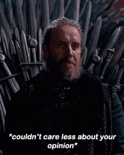 a man with a beard is sitting on a throne with a sword in his hand .