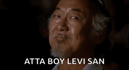 A Man With A Beard Is Smiling And Crying With The Words Atta Boy Levi San Written Below Him . GIF