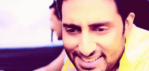 A Man With A Beard Is Smiling And Looking At The Camera . GIF