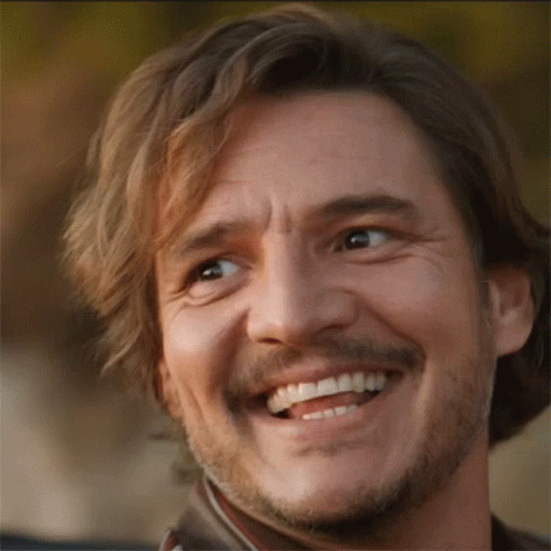 A Man With A Beard Is Smiling And Looking Up GIF