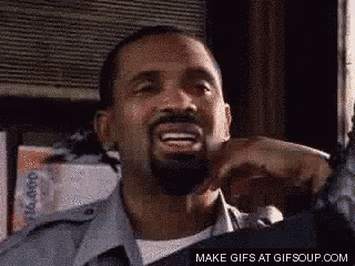 A Man With A Beard Is Smiling And Making A Funny Face In A Gif . GIF