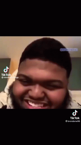 A Man With A Beard Is Smiling And Making A Funny Face On A Tiktok Video . GIF