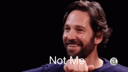 A Man With A Beard Is Smiling And Making A Gesture With His Hand That Says `` Not Me '' . GIF