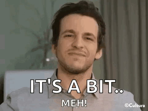 A Man With A Beard Is Smiling And Saying `` It 'S A Bit Meh ! '' GIF