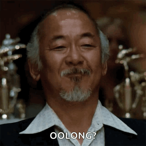 A Man With A Beard Is Smiling And Says Oolong ? GIF