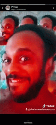 A Man With A Beard Is Smiling In A Tiktok Video . GIF