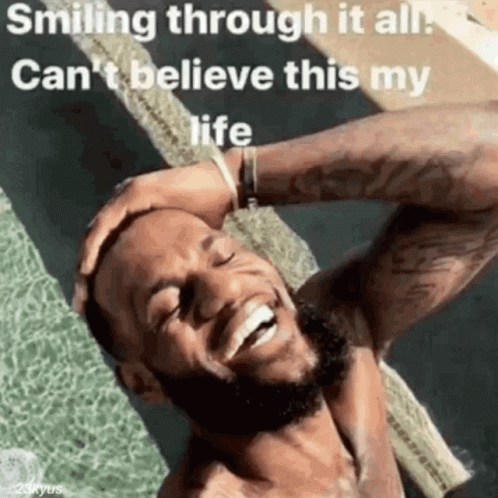 A Man With A Beard Is Smiling Through It All And Can 'T Believe This Is My Life . GIF