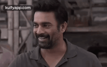 A Man With A Beard Is Smiling With His Eyes Closed In A Black And White Photo . GIF