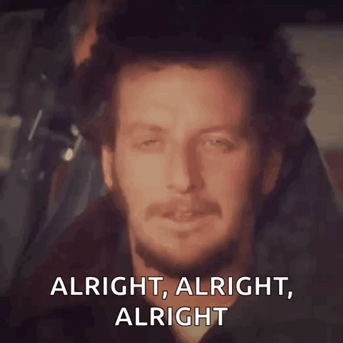 A Man With A Beard Is Smiling With The Words Alright Alright Alright GIF