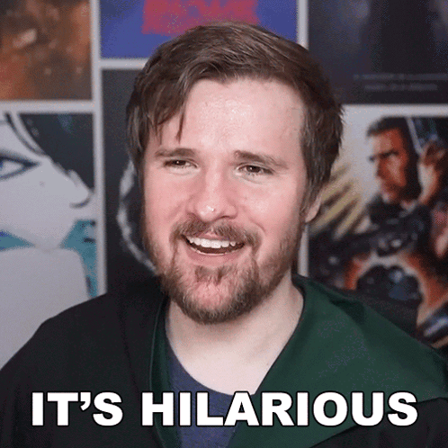 A Man With A Beard Is Smiling With The Words It 'S Hilarious Below Him GIF