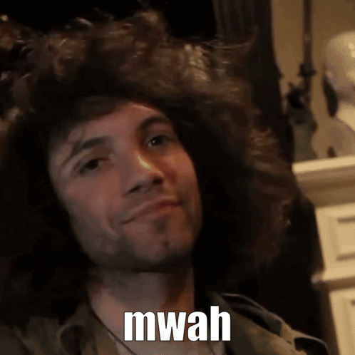 A Man With A Beard Is Smiling With The Words Mwah Written On His Face GIF